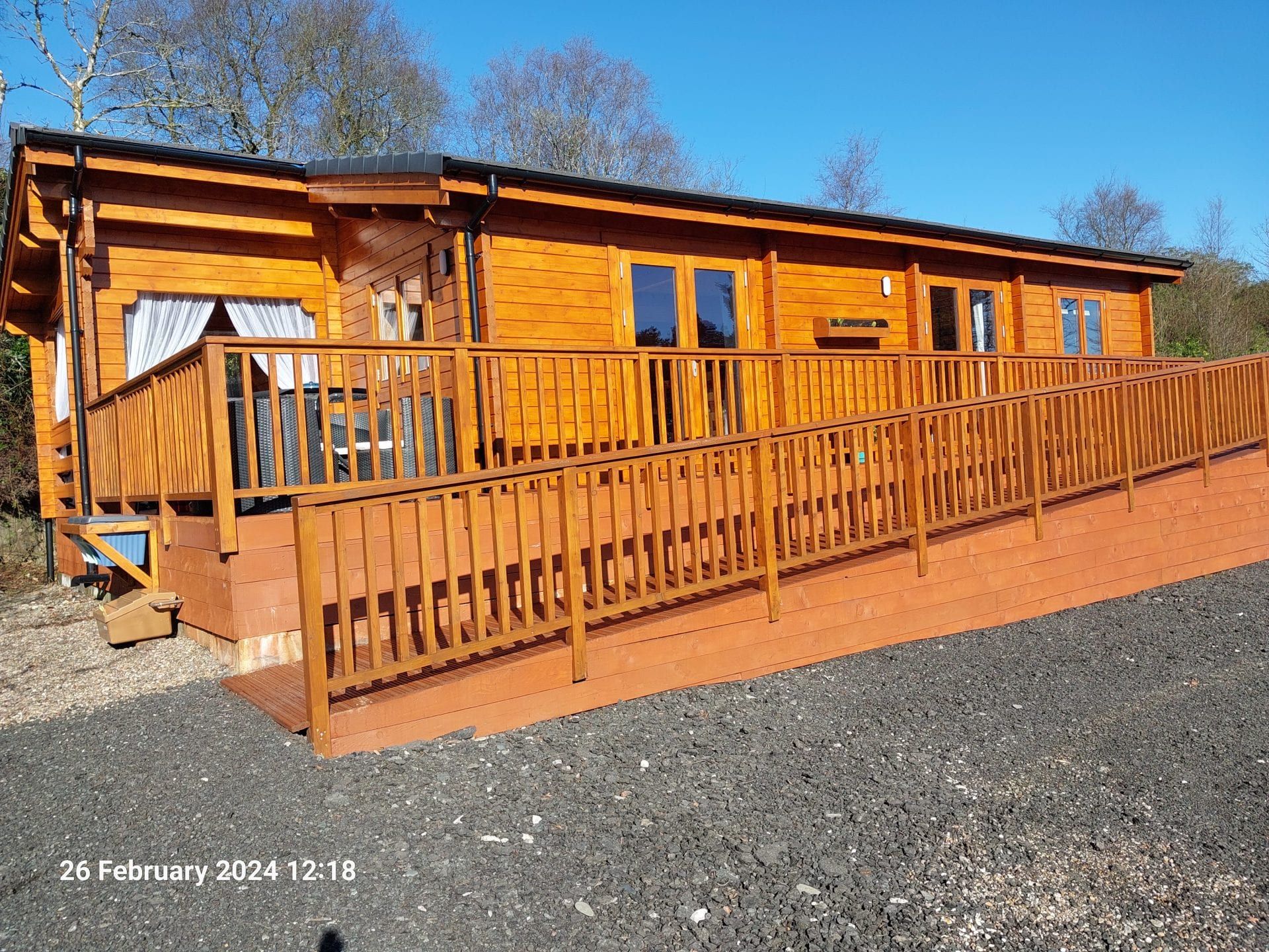 Little Lodge timber holiday lodge with decking at Torwood Country Lodges, Newton Stewart