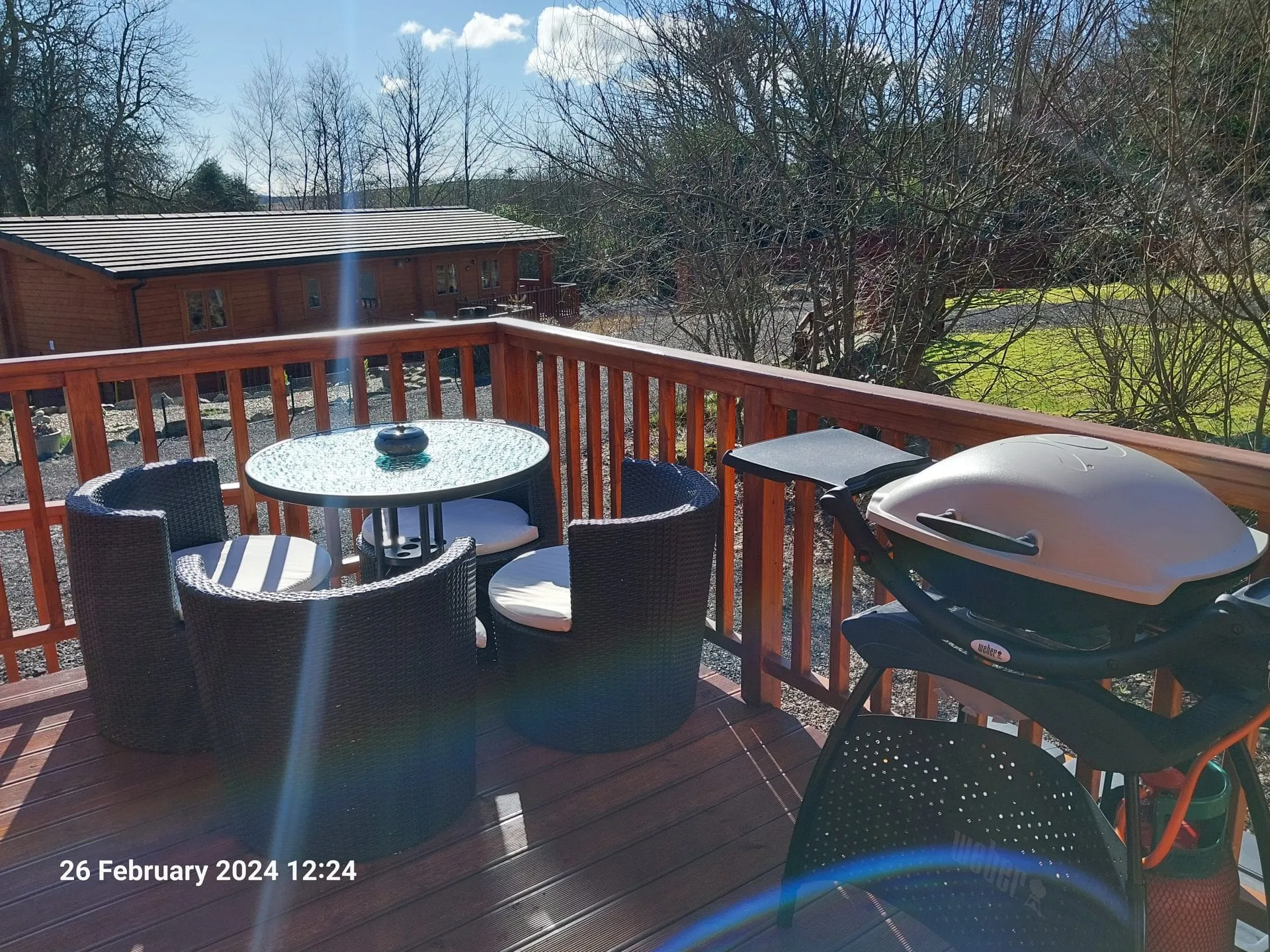 Decking with outdoor seating and gas barbeque at Little Lodge, Torwood Country Lodges, Newton Stewart