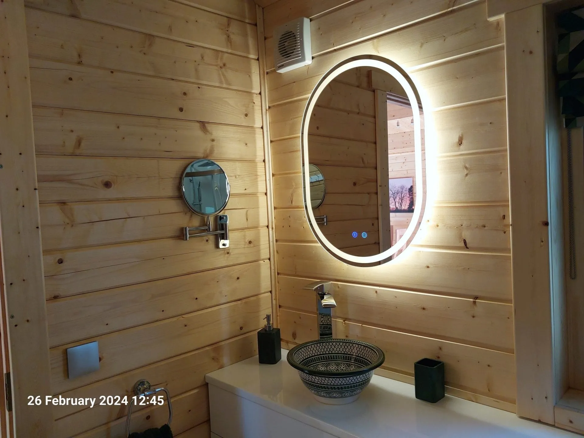 Bathroom basin and illuminated mirror in Little Lodge, Torwood Country Lodges, Newton Stewart