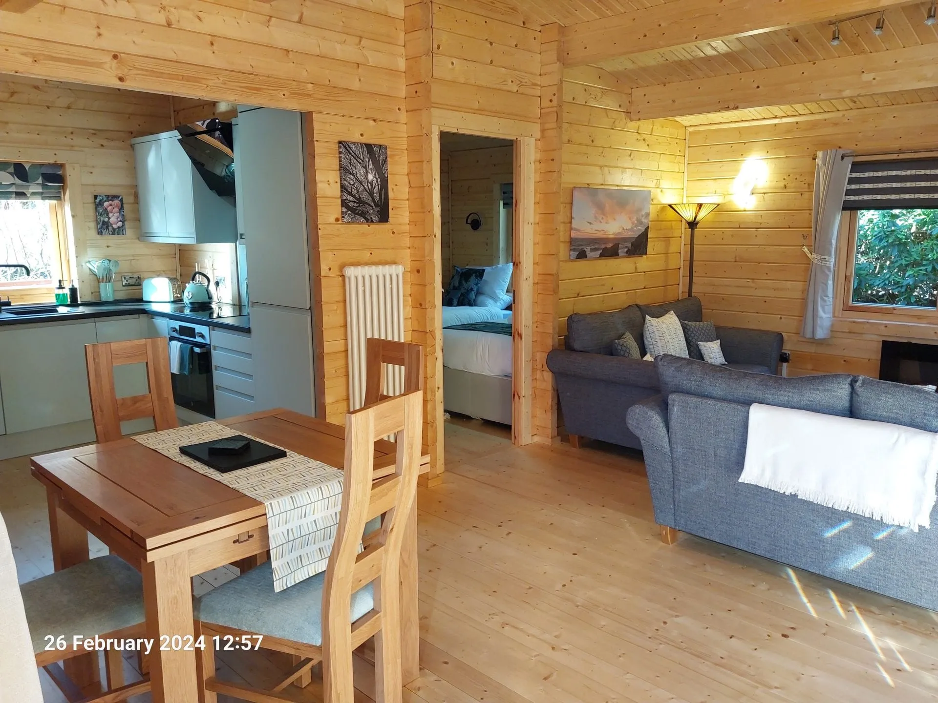 Dining table and living area in Little Lodge, Torwood Country Lodges, Newton Stewart