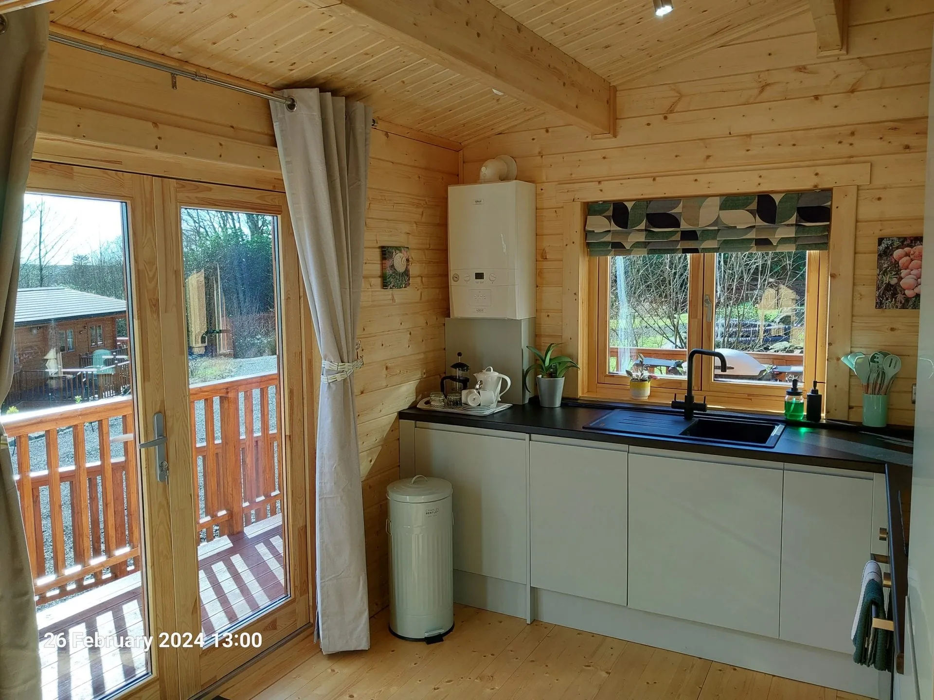 Kitchen with patio doors to the decking at Little Lodge, Torwood Country Lodges, Newton Stewart