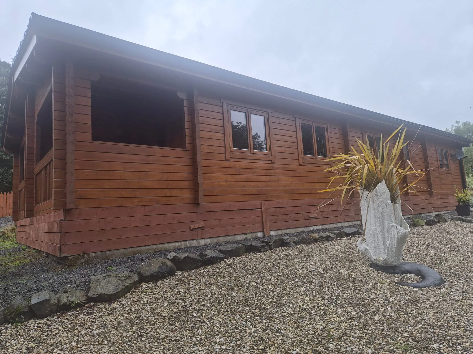 Solid timber lodge and landscaped garden, Torwood Country Lodges, Dumfries and Galloway